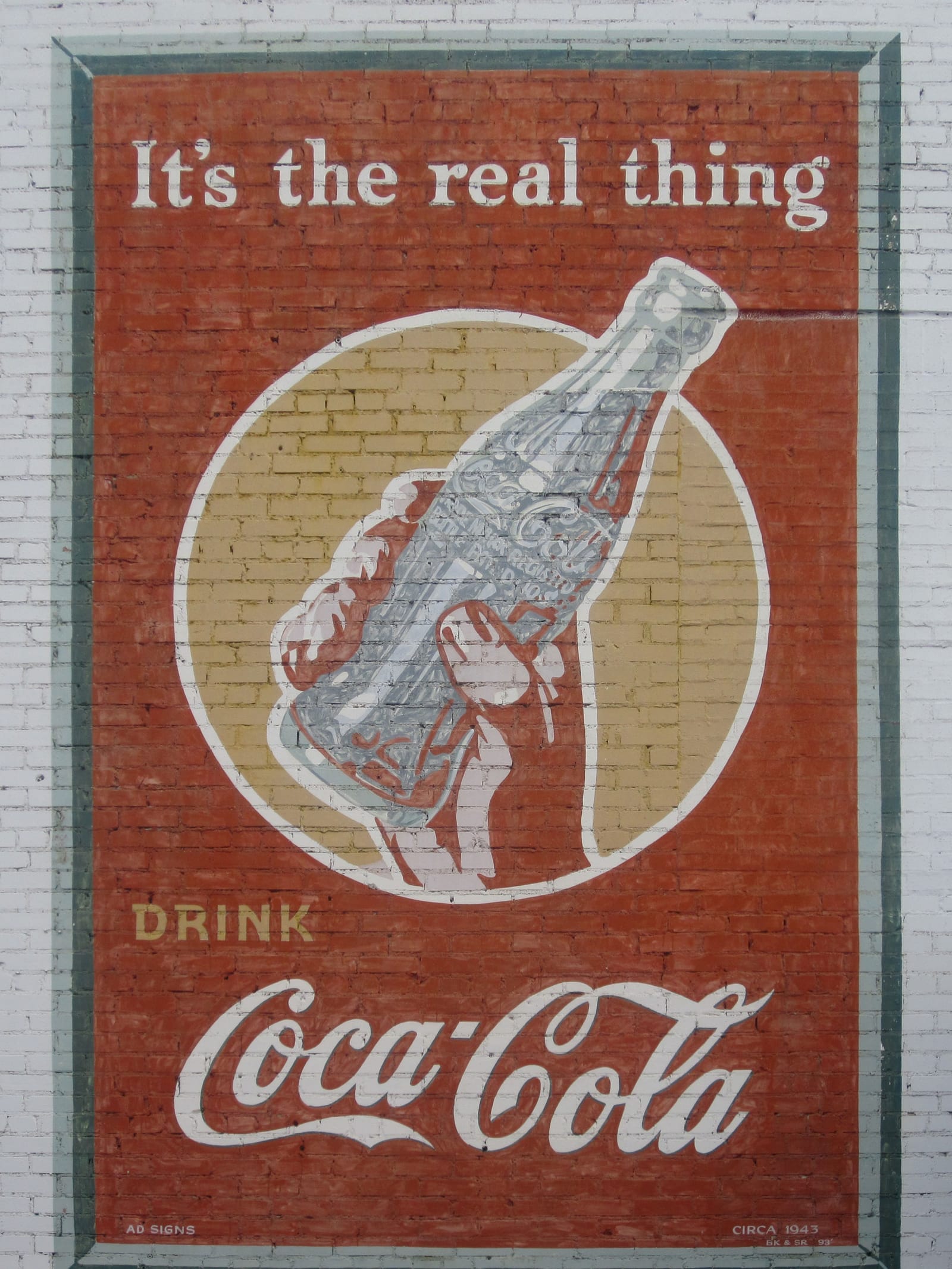 Mural ad for Coca Cola reading: "It's the real thing"